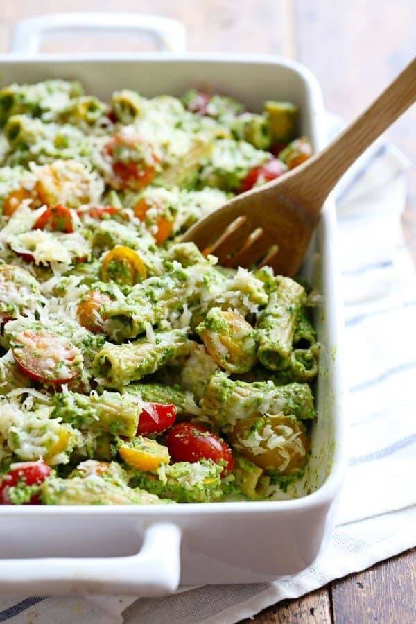 This Healthy Baked Pesto Rigatoni is tossed with heirloom tomatoes and a saucy spinach pesto that will knock your socks off! 340 calories. | pinchofyum.com