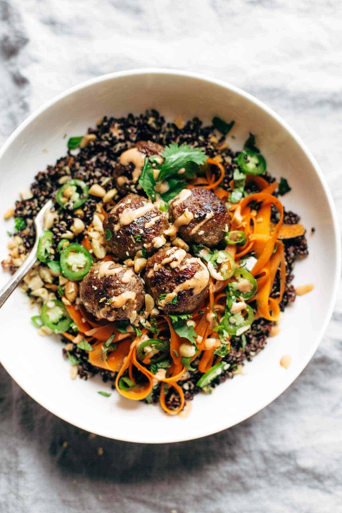 Banh Mi Bowls! A quick and easy meal featuring quinoa or rice topped with quick pickled carrots, herbs, peanuts, and easy lemongrass pork meatballs, all covered with spicy mayo. | pinchofyum.com