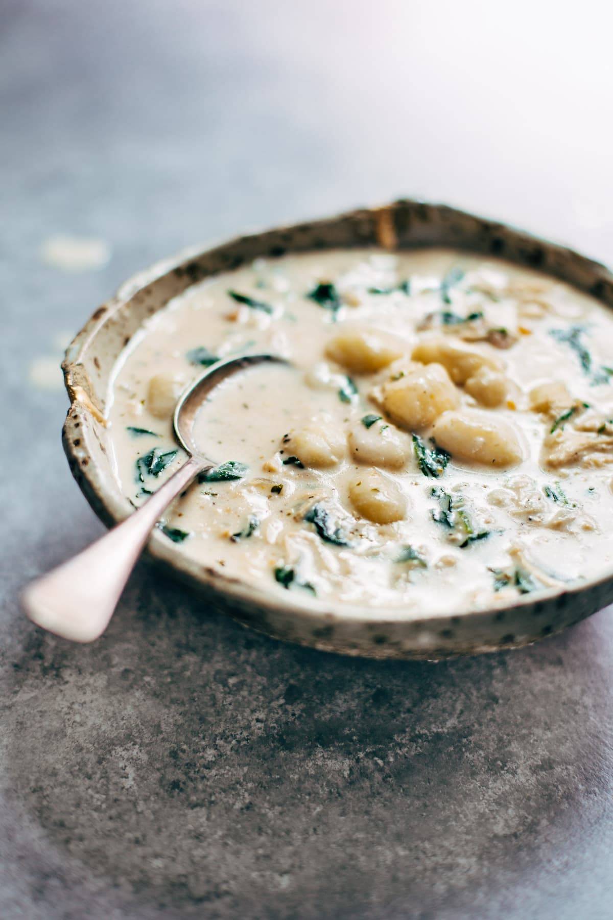 Crockpot Chicken Gnocchi Soup - a simple, velvety, back-to-basics meal! Easy to make with familiar ingredients - chicken, garlic, spinach, carrots, evaporated milk, and bacon. | pinchofyum.com
