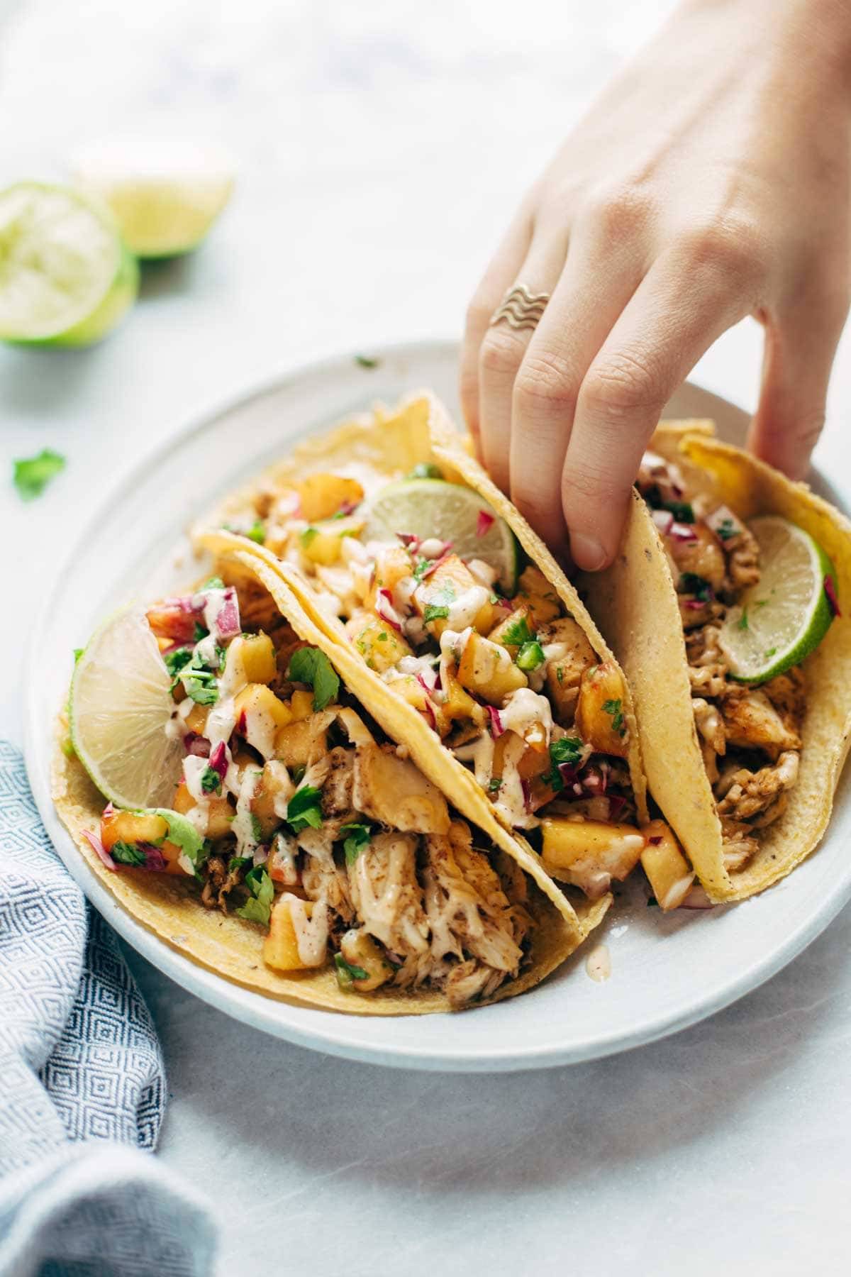 Chili Lime Fish Tacos - mind-blowingly delicious and easy. 5 basic ingredients for the fish, and a quick peach salsa to add some color and flavor.