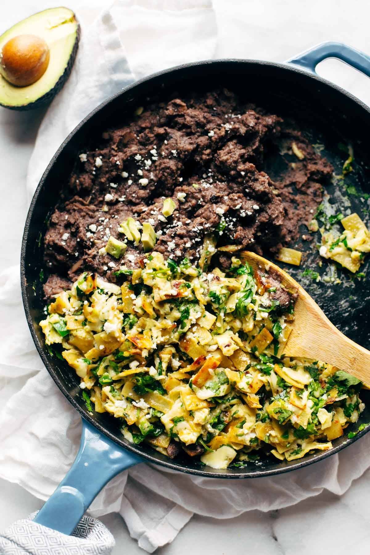 Migas - eggs scrambled with crispy tortillas, garlic, jalapeño, and melted cheese served with black beans and avocado. Quick, easy, and SO DELICIOUS. Breakfast, lunch, dinner, or brunch! | pinchofyum.com
