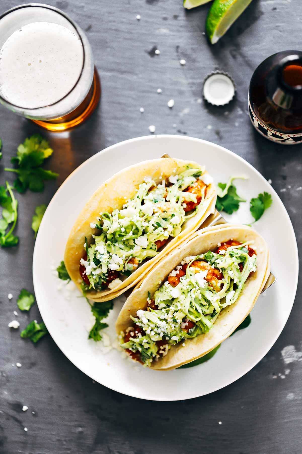 Spicy Shrimp Tacos with Garlic Cilantro Lime Slaw - ready in 30 minutes and loaded with avocado, spicy shrimp, and a homemade creamy lime slaw.  HELLO YUMMY!
