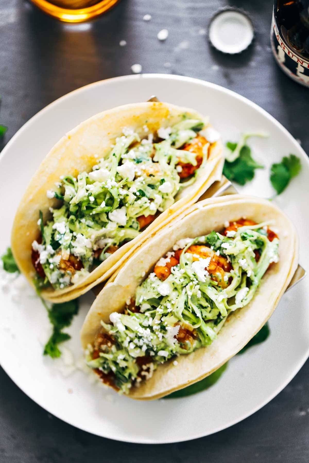 Spicy Shrimp Tacos with Garlic Cilantro Lime Slaw - ready in 30 minutes and loaded with avocado, spicy shrimp, and a homemade creamy lime slaw.  Best tacos I've ever had!