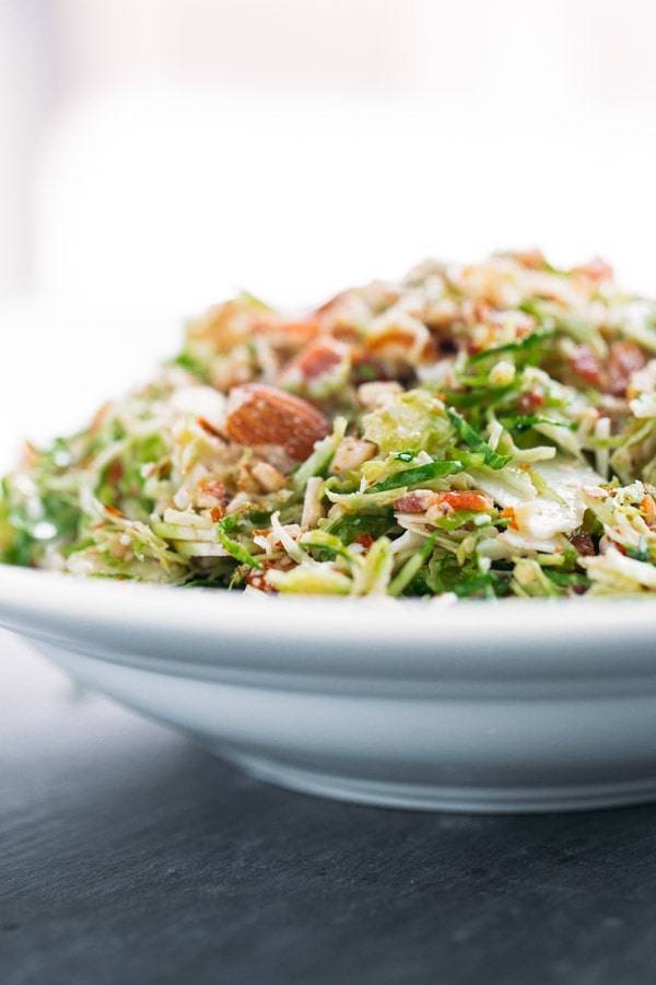 Bacon and Brussels Sprout Salad - always everyone's favorite! Bacon, almonds, Parmesan, light citrus vinaigrette, and paper-thin brussels sprouts! 