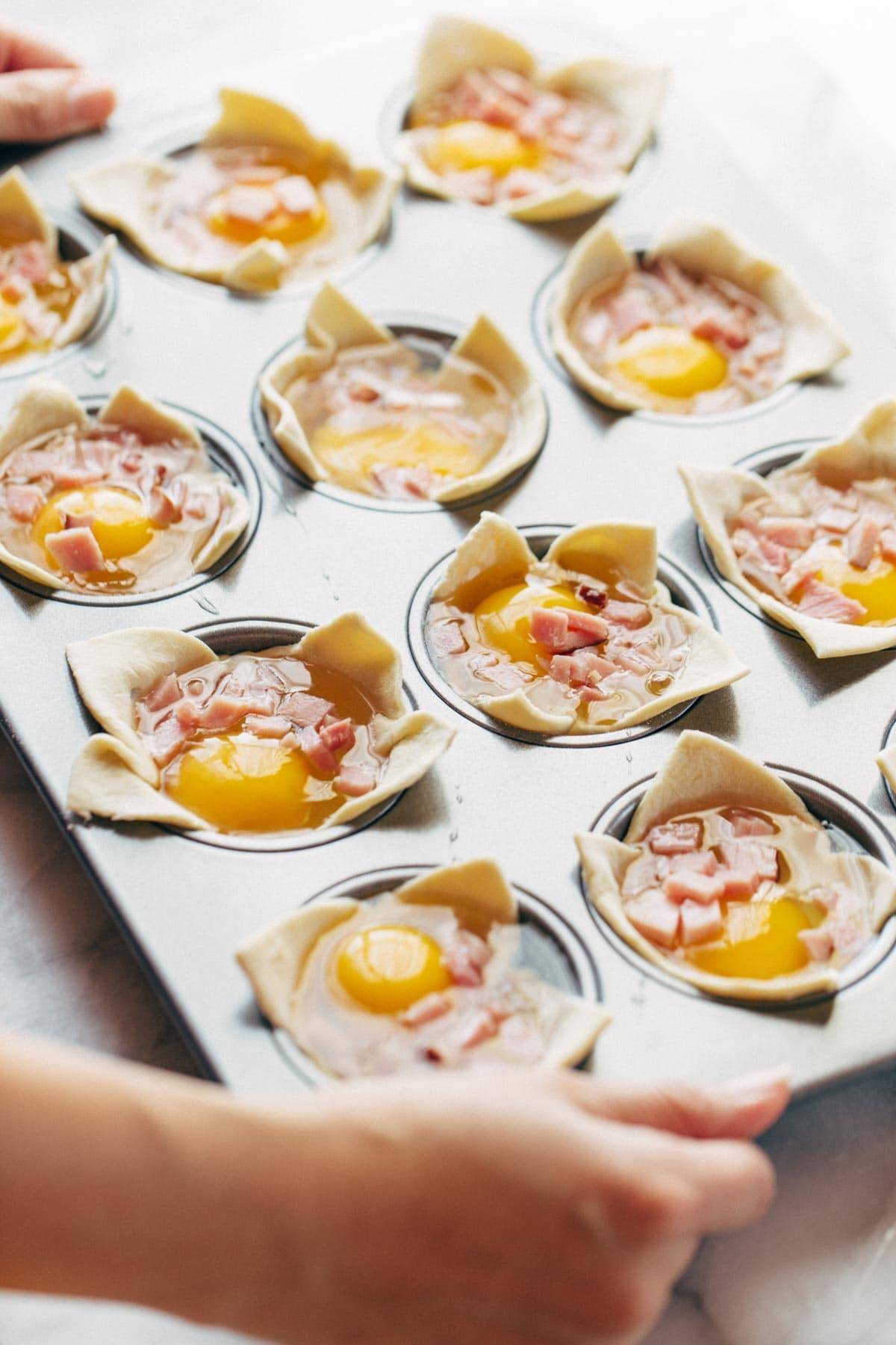 Ham, Egg, and Cheese Brunch Cups in muffin tin before baking.