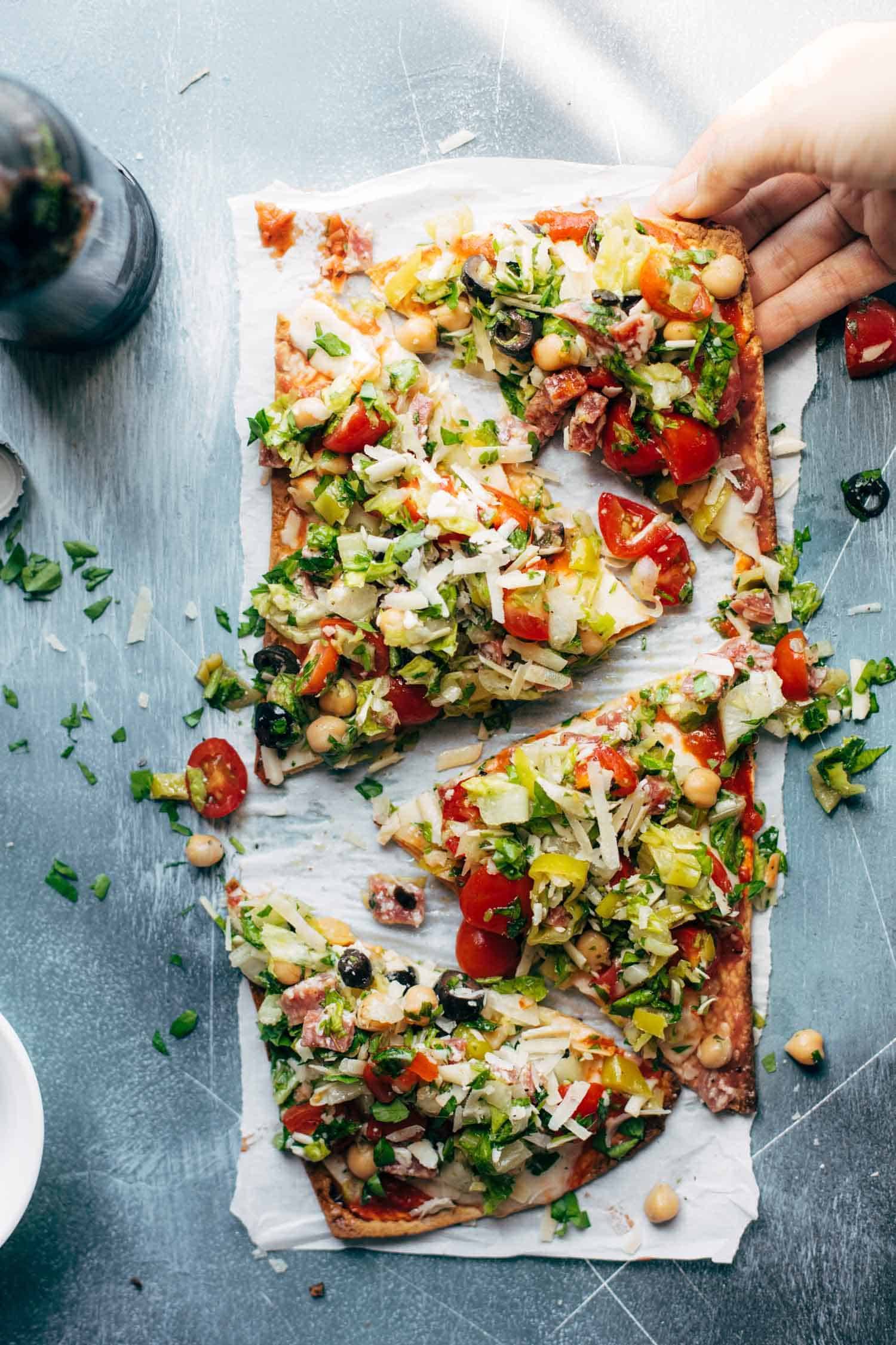 Chopped Salad Pizza - a tangy Italian-style chopped salad loaded on top of a crispy flatbread crust with tomato sauce and mozzarella. my favorite crunchy, tangy food for summer! | pinchofyum.com