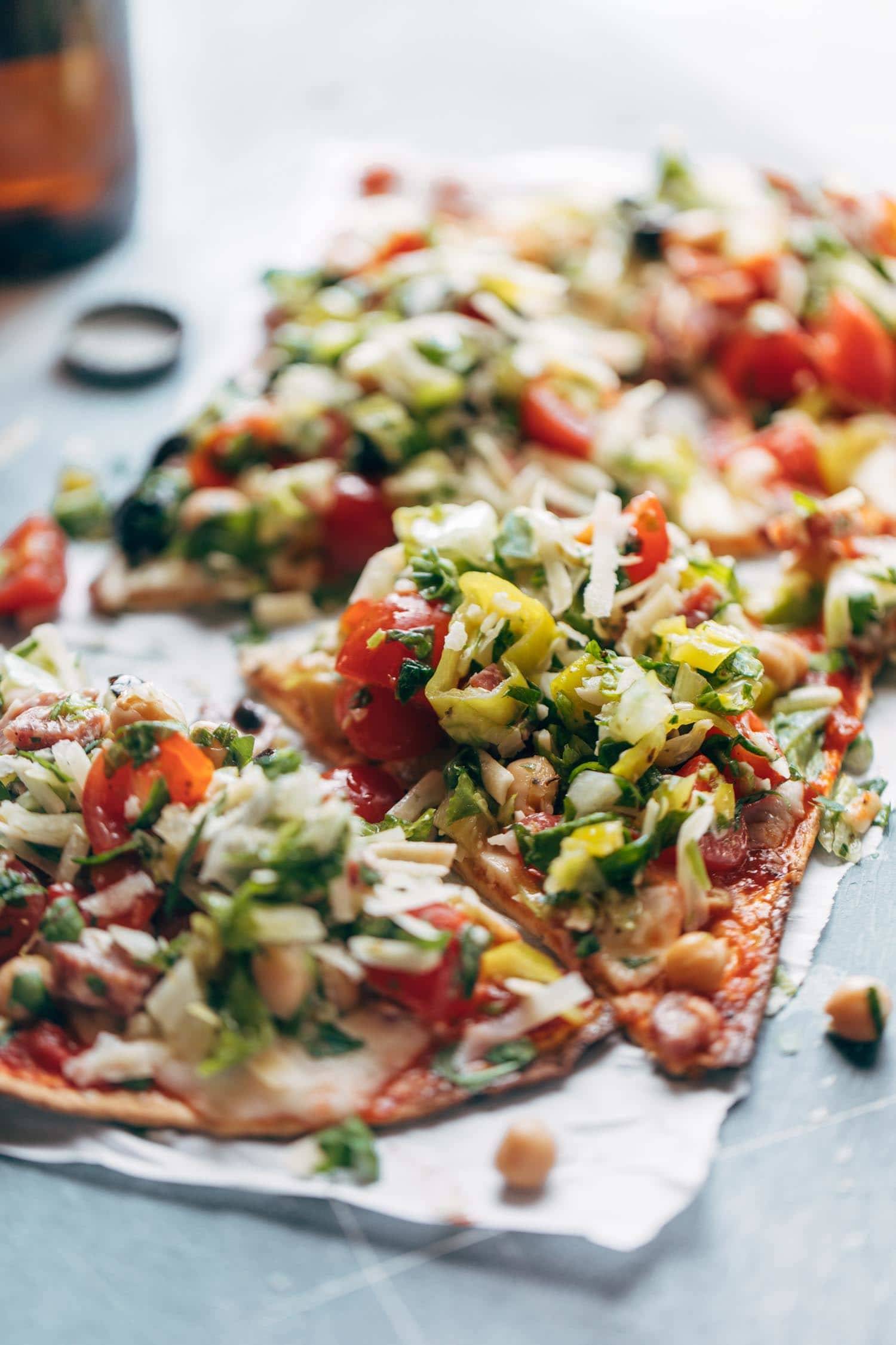 Chopped Salad Pizza - a tangy Italian-style chopped salad loaded on top of a crispy flatbread crust with tomato sauce and mozzarella. my favorite crunchy, tangy food for summer! | pinchofyum.com