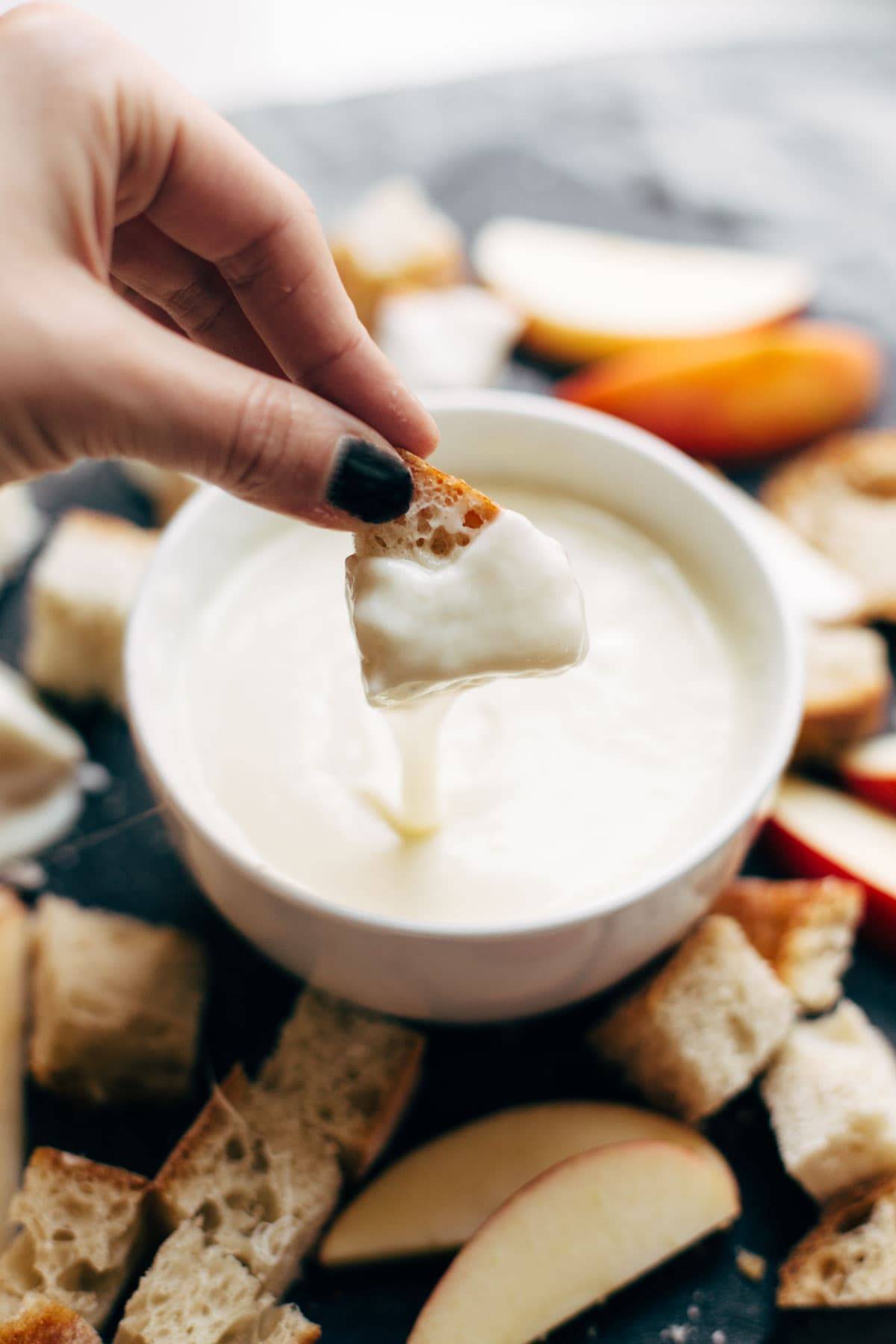 Cheese Fondue - all you need is garlic, wine, cornstarch, and cheese! So versatile and perfect for the holidays. | pinchofyum.com