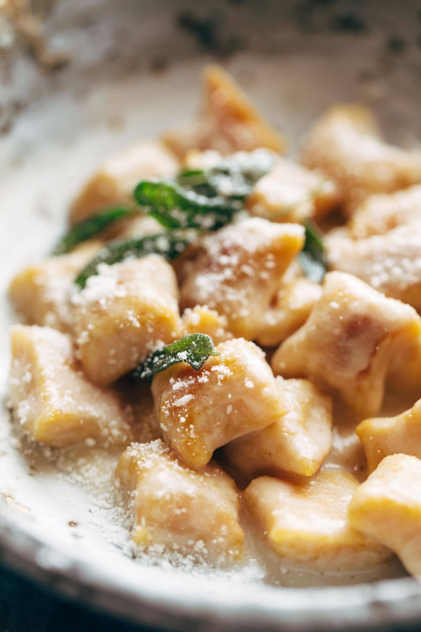 Pumpkin Gnocchi! So incredibly pillowy and delicious. Topped with a 5 ingredient sage garlic butter sauce that will blow your mind. | pinchofyum.com