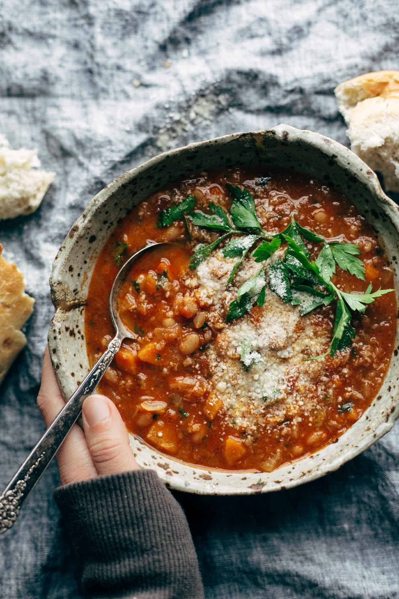Instant Pot Minestrone Soup! Thick + chunky with veggies, garlic, beans, pesto, tomato sauce. Topped with Parm and served with bread. Easily made vegan. | pinchofyum.com