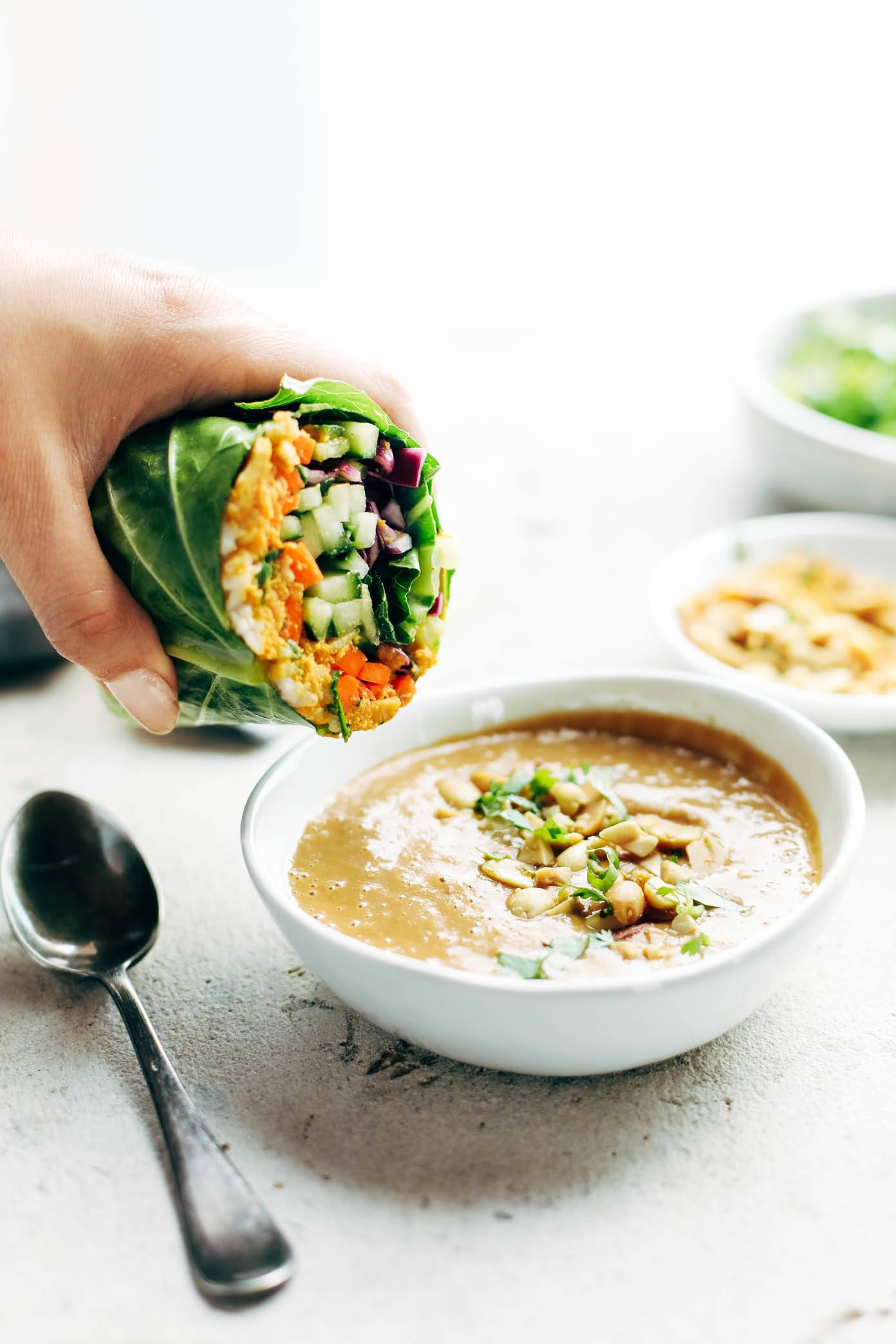 Detox Rainbow Roll-Ups - with curry hummus and veggies in a collard leaf, dunked in peanut sauce! most beautiful healthy desk lunch! | pinchofyum.com