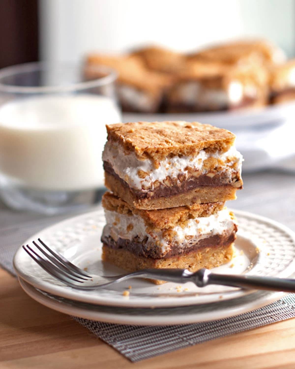 These s'mores bars have peanut butter layered in between marshmallow fluff, chocolate, and a graham cookie base. Just like s'mores! | pinchofyum.com